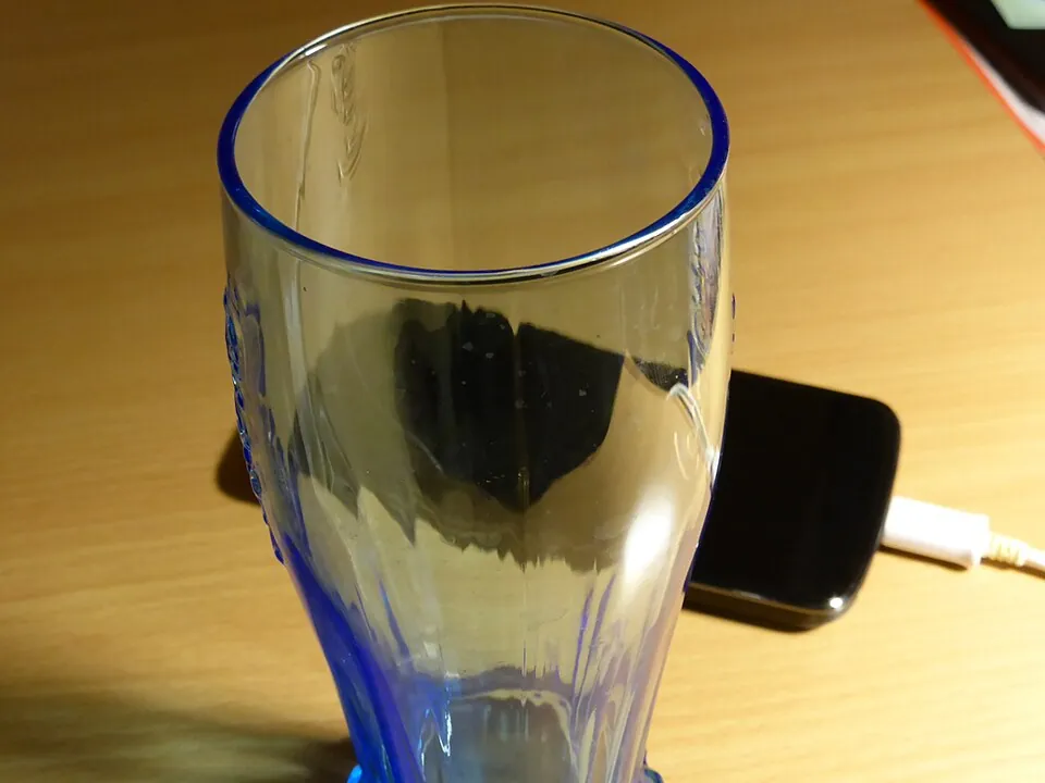 机の上のグラスとスマートフォン